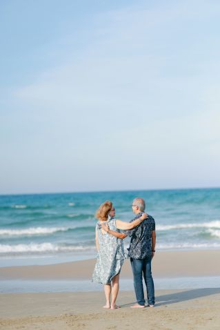 Seniors enjoying a quiet moment on a park bench during a serene sunset.